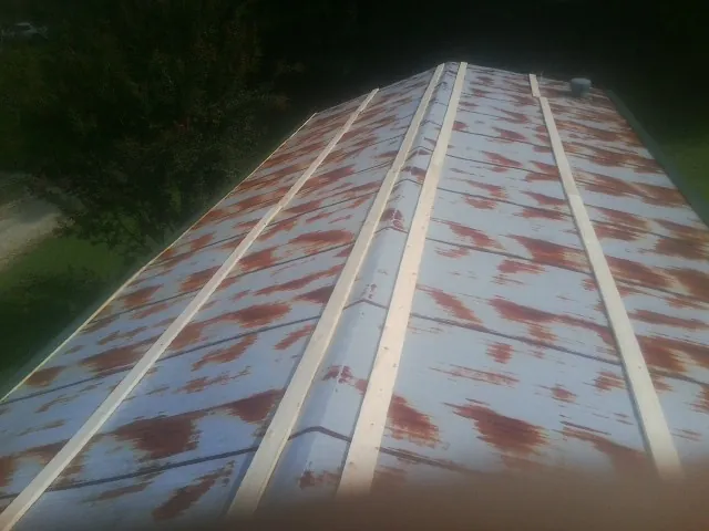 Rusted metal roof panels with new wood purlins before replacement — Storm Damage Roof Repair in Midland Park by Roofing Brothers