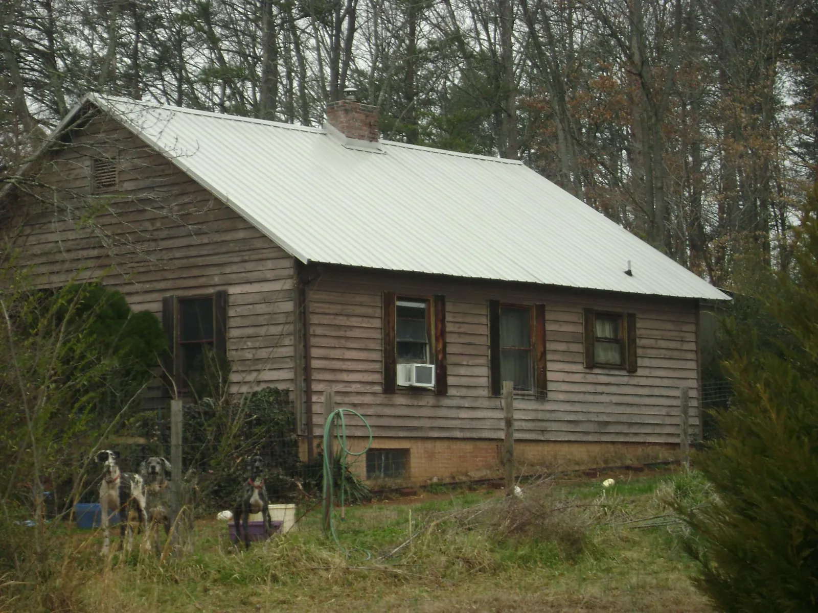 White metal roof on an old wood sided farmhouse, from a Asphalt Shingle Roof Repair job in Midland Park